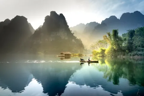 On raft near misty mountains